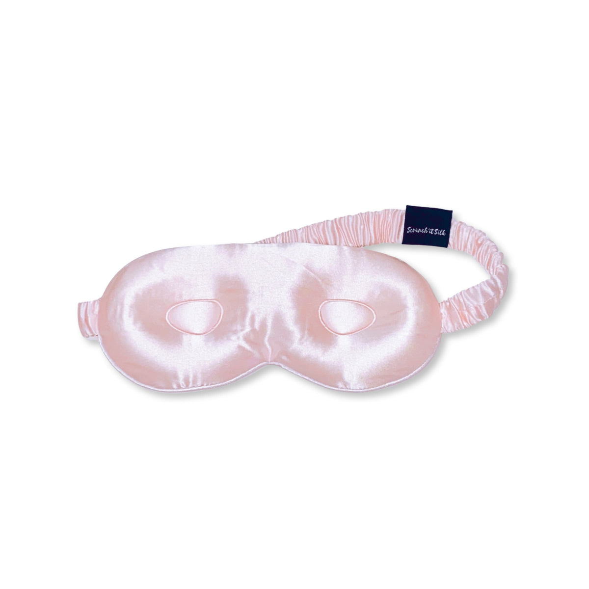 Masque de sommeil rose en soie de mûrier avec bande élastique, présenté sur fond blanc - Scrunch'it Silk.