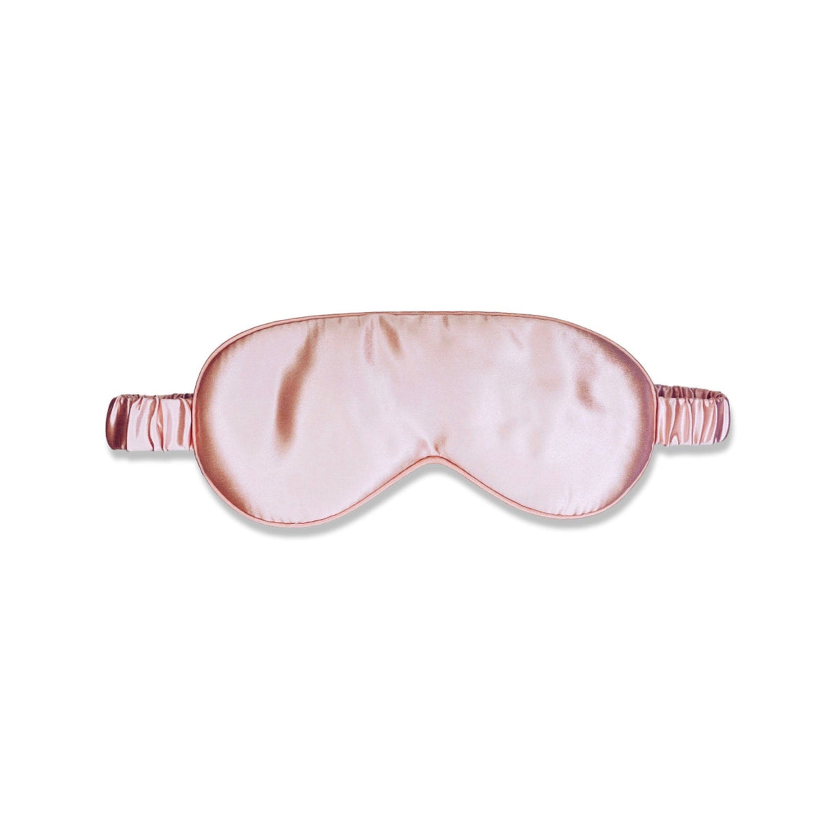 Masque de sommeil en soie rose disposé sur fond blanc - scrunch'it Silk